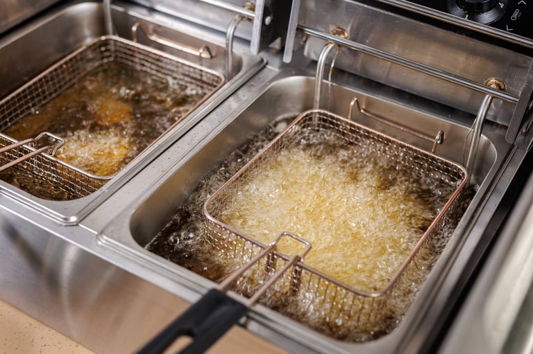 Frying potatoes in fryer for french fries restaurant