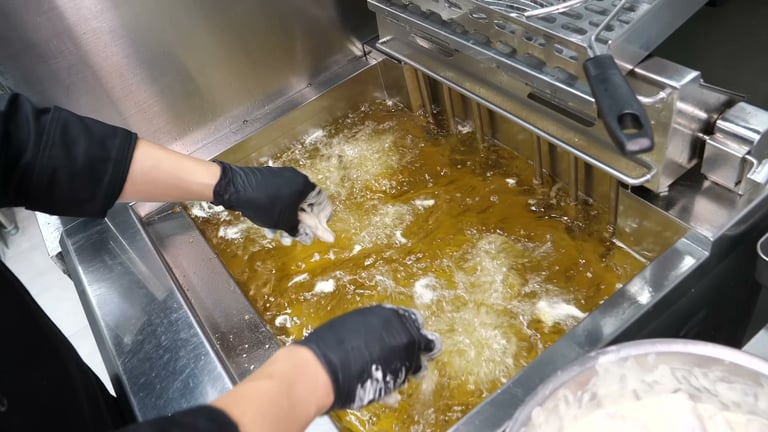 Commercial kitchen with industrial deep fryer for cooking oil management